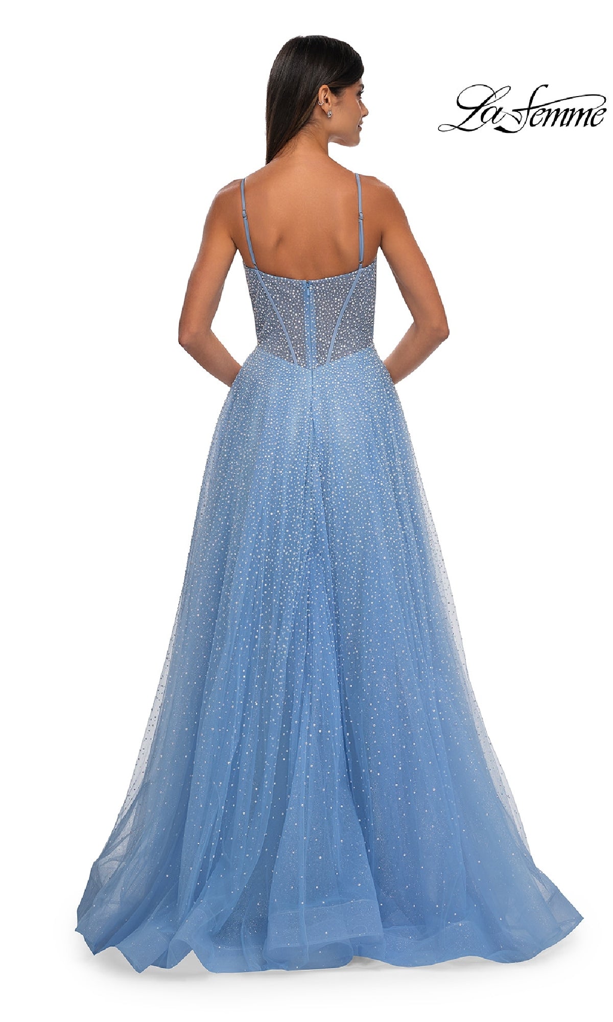 A woman faces away from the camera in the Pearl Classic Long Prom Dress: La Femme 32644, a light blue gown featuring thin straps, pearl beading, and sparkling details. The La Femme logo is displayed in the top right corner.